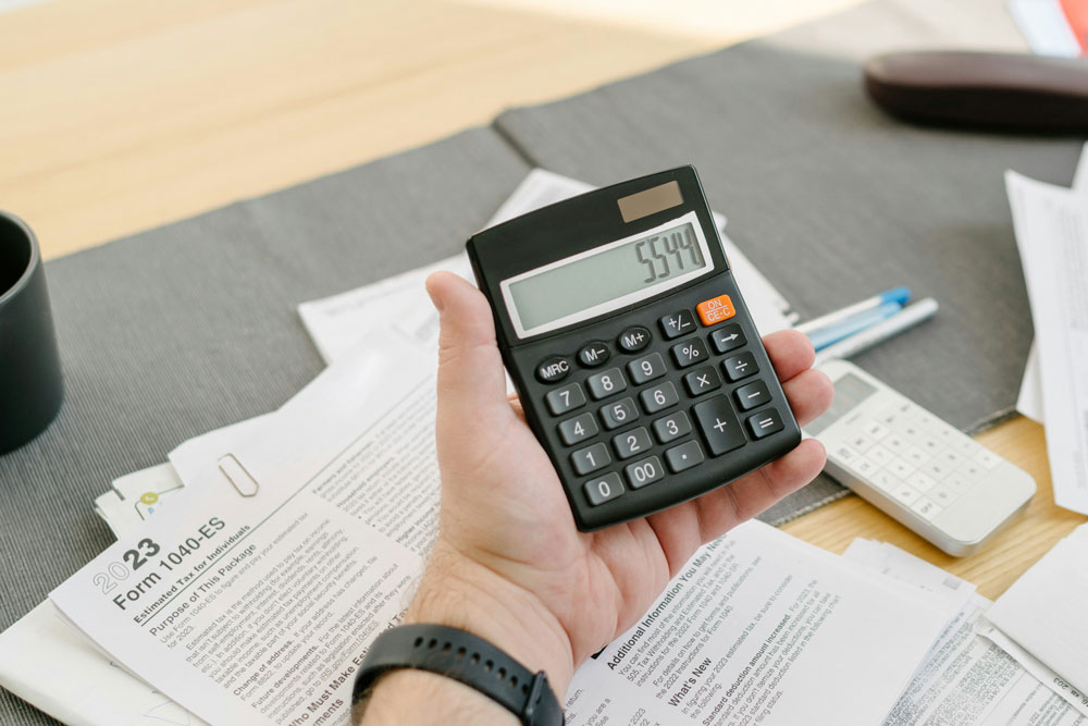 hand holding a calculator